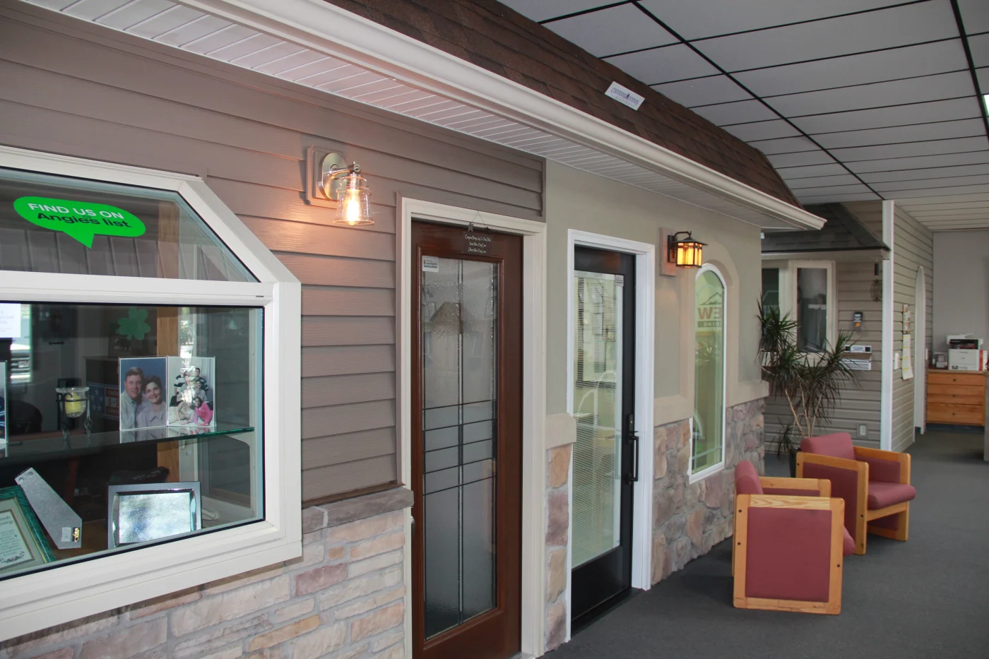 Another angle inside the Peakview Windows, Siding & Stucco showroom in Colorado Springs showing different kinds of exterior remodeling systems they install on fake walls with siding options, gutters, veneers, and windows.