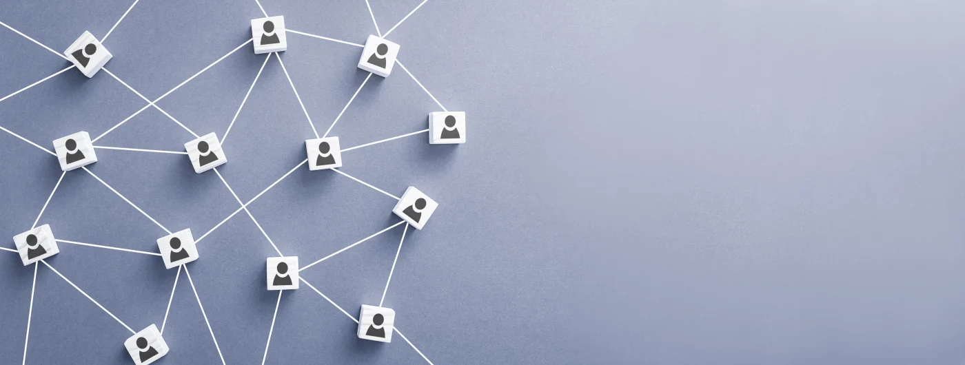 To the right are small white boxes arranged on a light gray background. Each has a small person icon on it. There are white lines or strings connecting them, showing a strong company culture.
