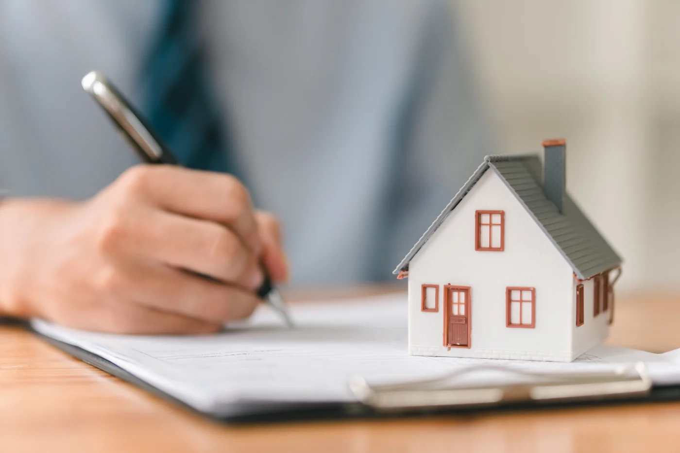 A homeowner using a pen to fill out some paperwork, or an estimate, during an entry door consultation.