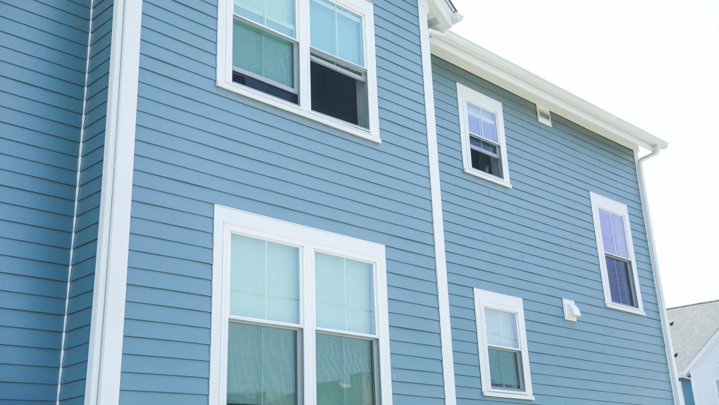 The side of a home with blue siding and white trim