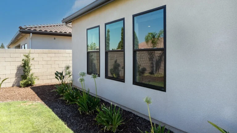 Exterior of a home with three black windows