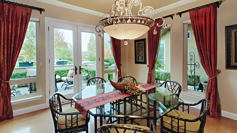 A dining area with a French door leading to the patio