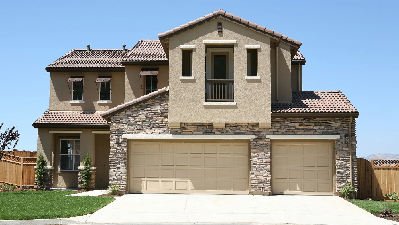 A home with a tan stucco exterior