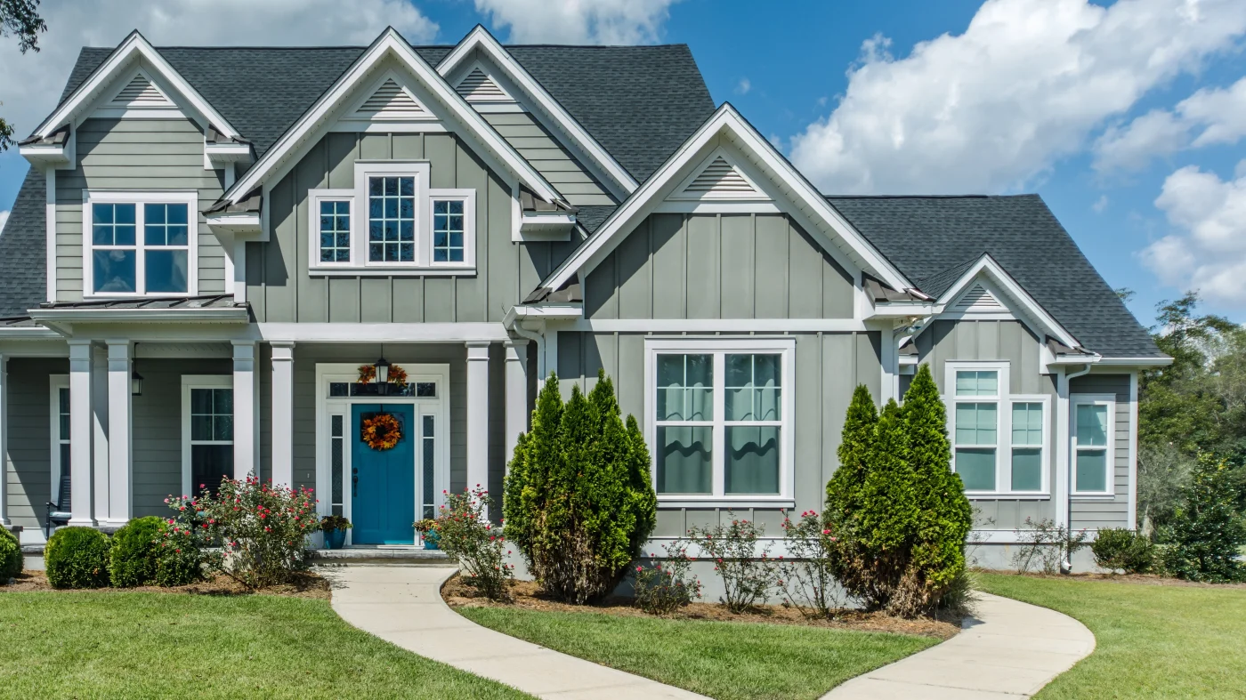A home with green fiber cement siding and white trim