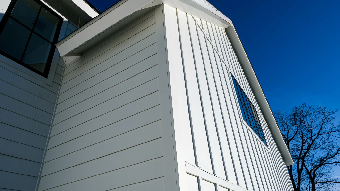 White fiber cement siding installed vertically and horizontally.
