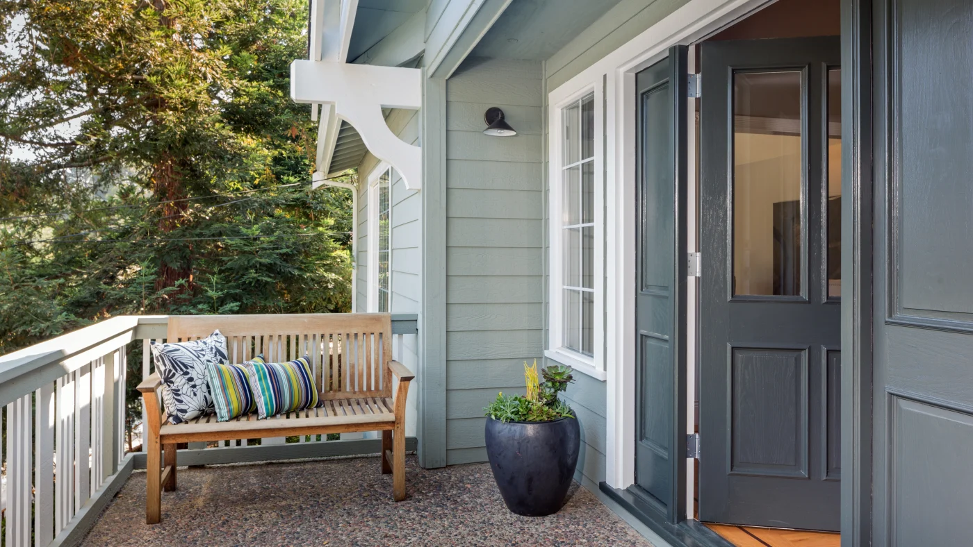 An entryway on a porch with the door open