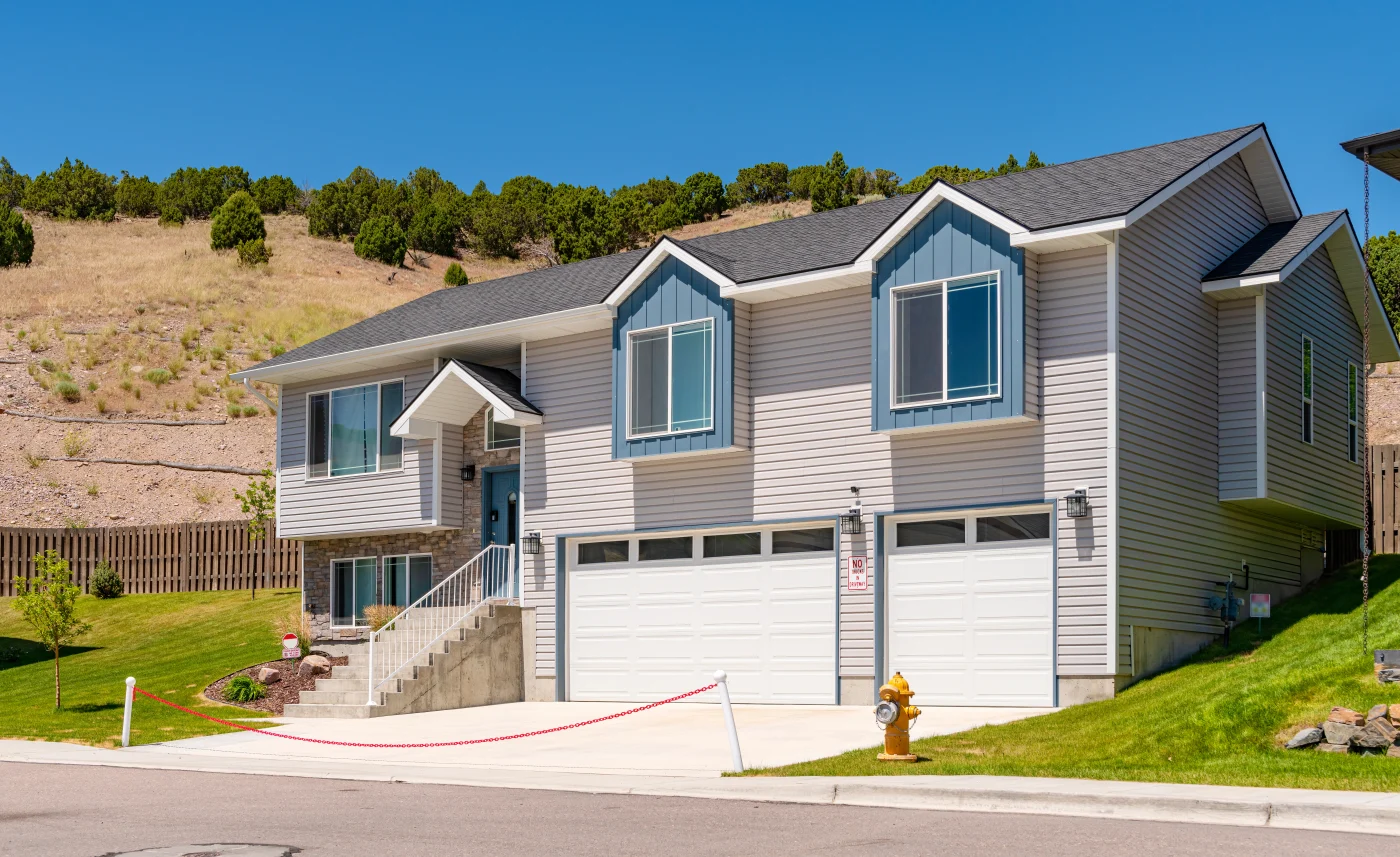 A brand-new house with cream-colored vinyl siding
