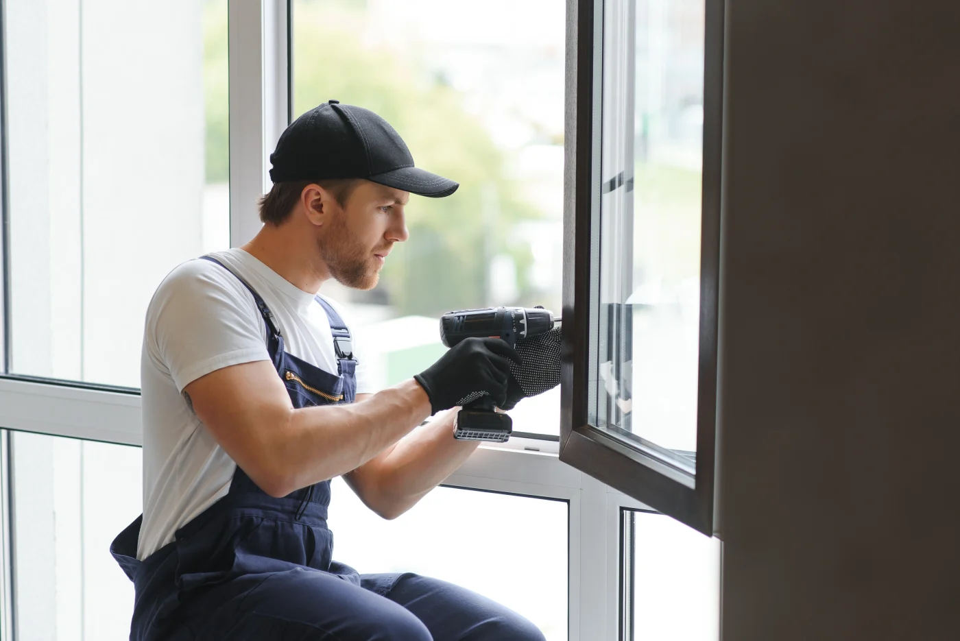 An expert window installer is attaching a casement window to a house.