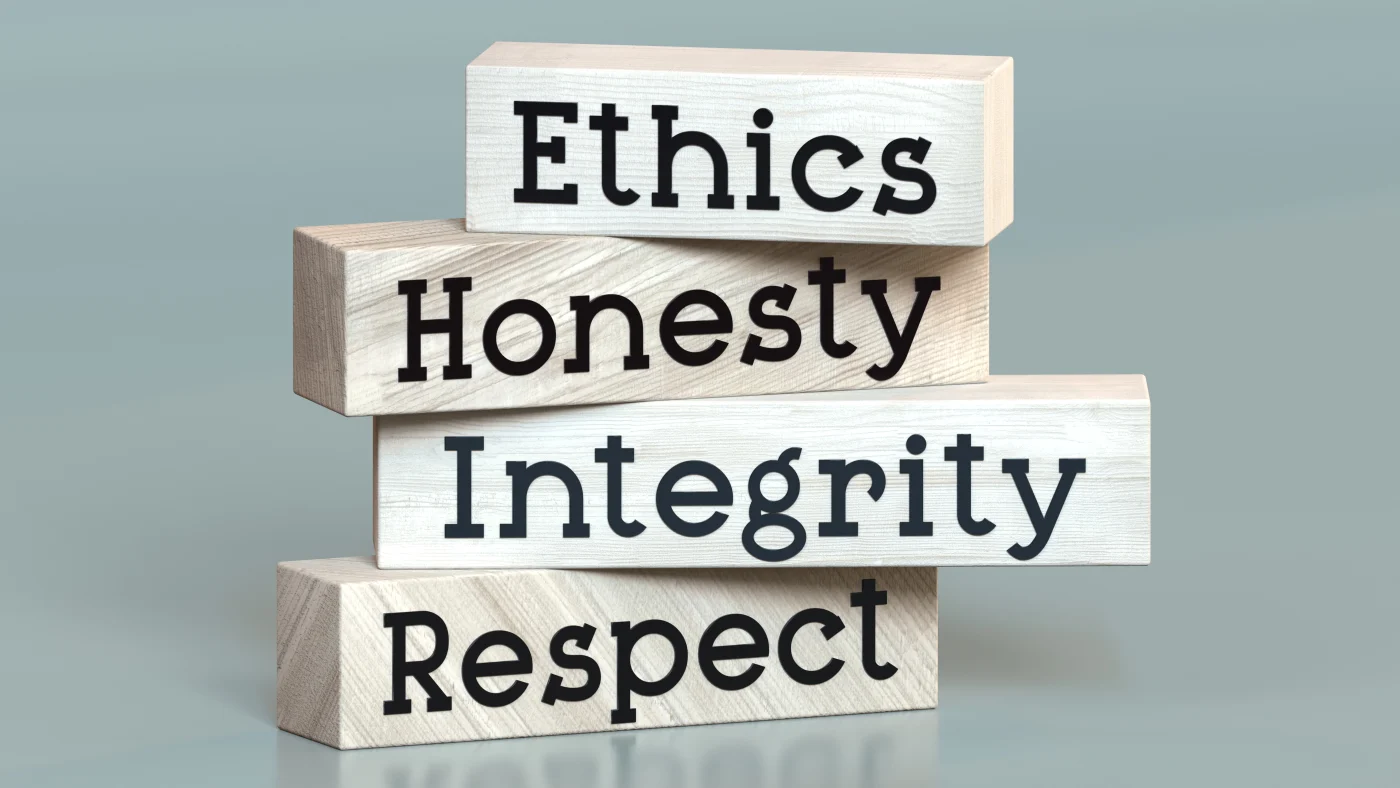 Four blocks stacked on top of one another, with the words Ethics, Honesty, Integrity, and Respect written on them