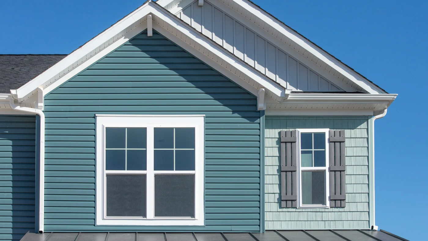 A home with green siding in two different shades