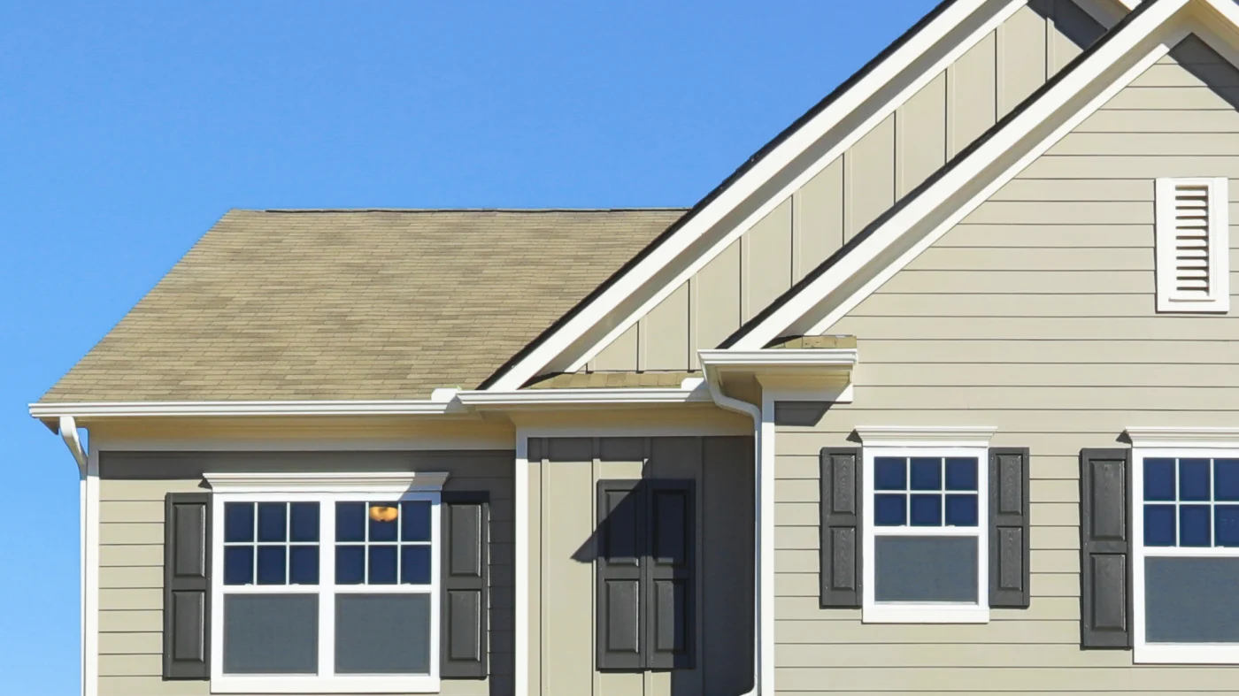 The second floor of a home with tan siding and white trim