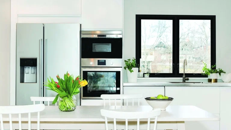 A kitchen with a black with and stainless steel appliances