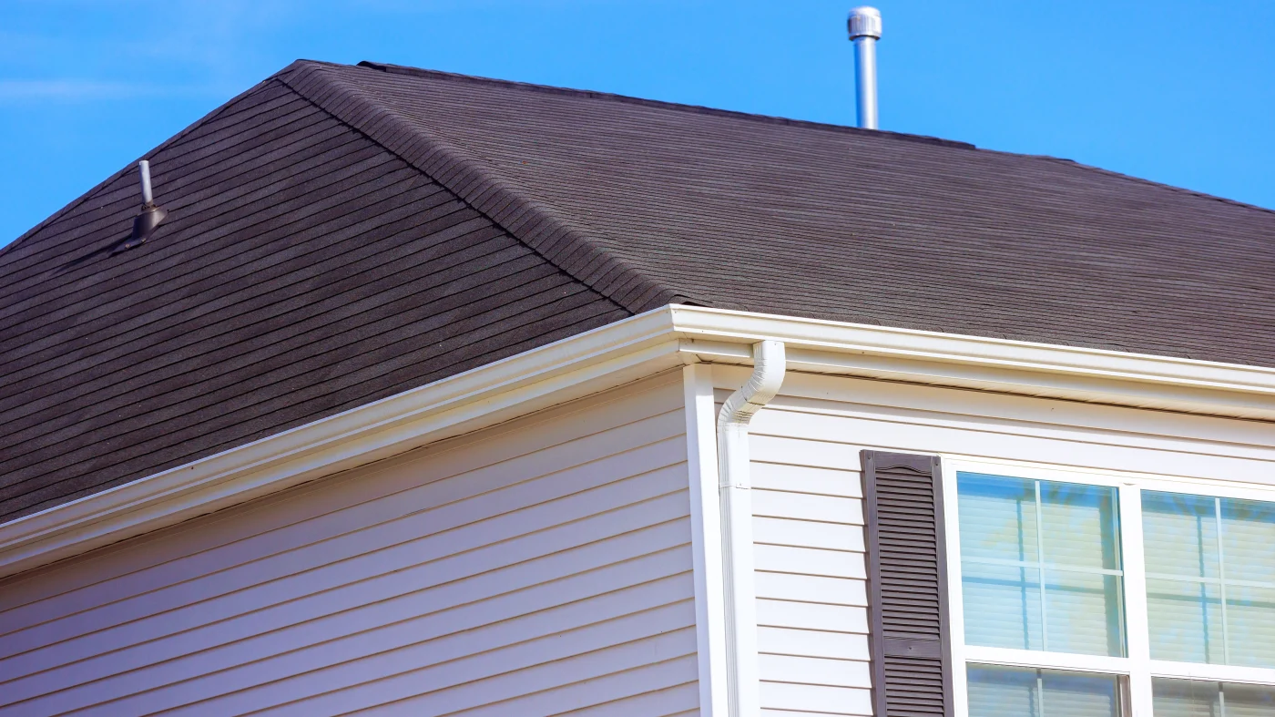 White seamless gutters installed on a home with white siding