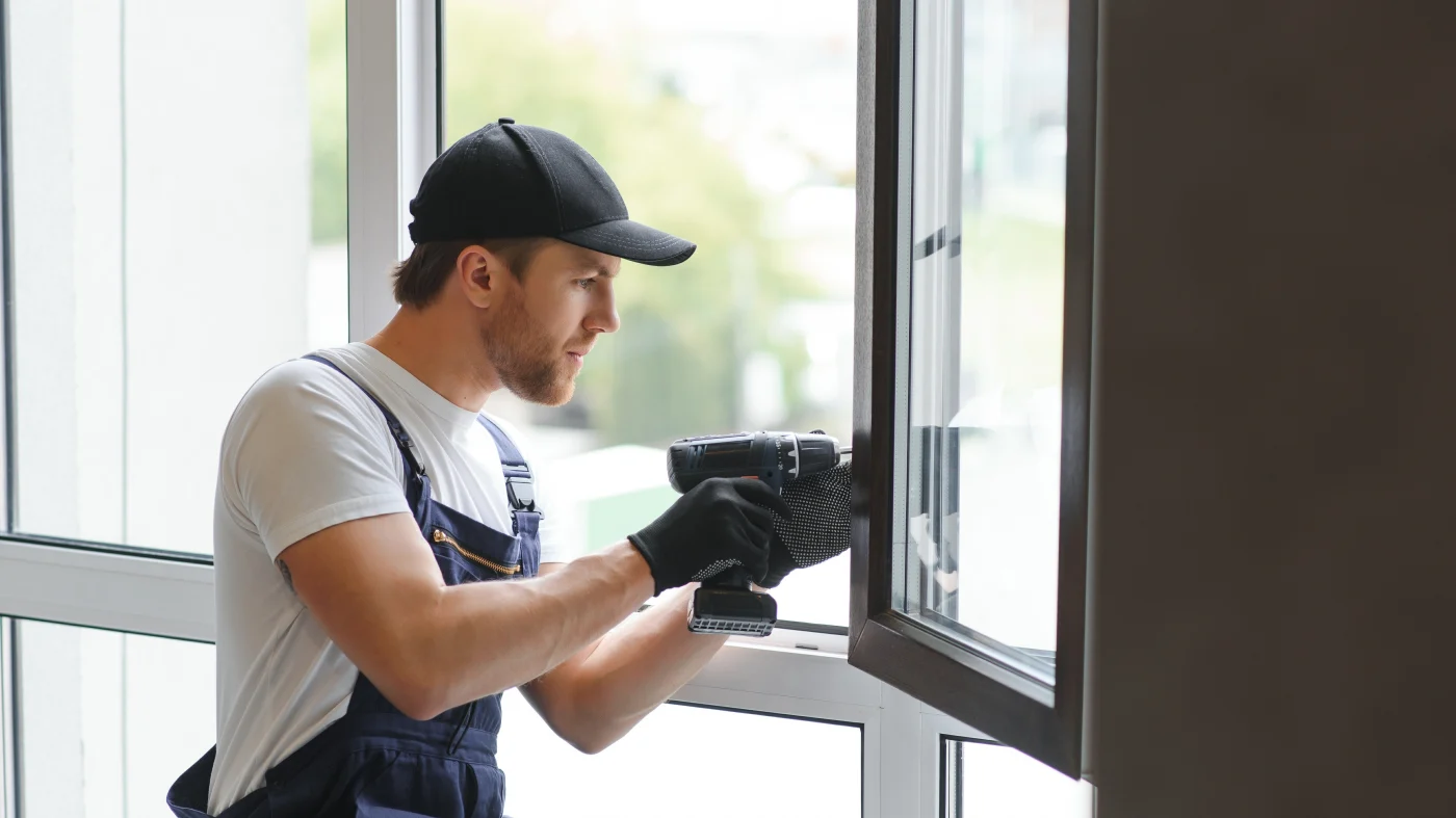 A window installer finishes a replacement window installation.