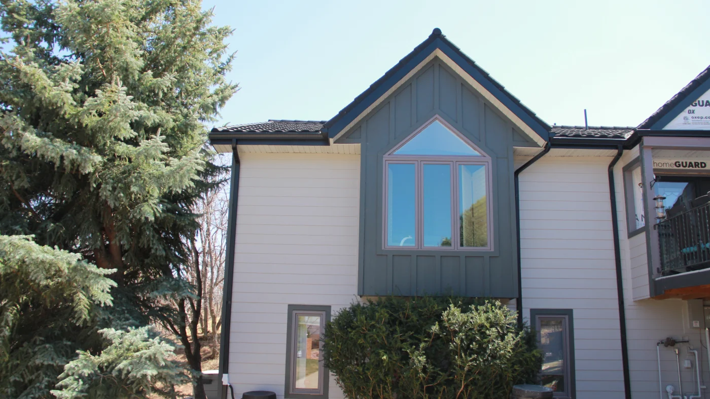 A home with white and green siding.