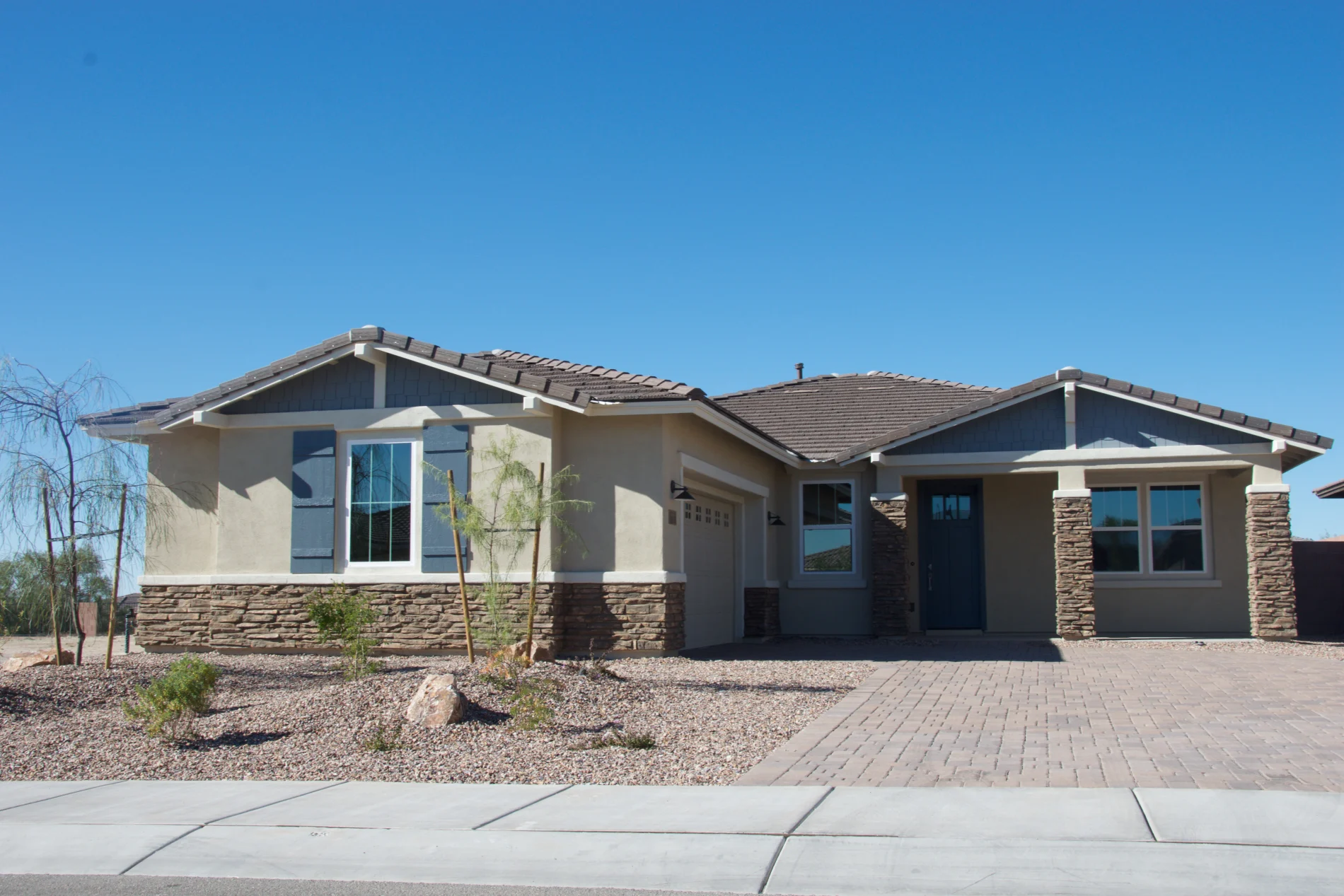 A single-story home with stucco and stone veneer.