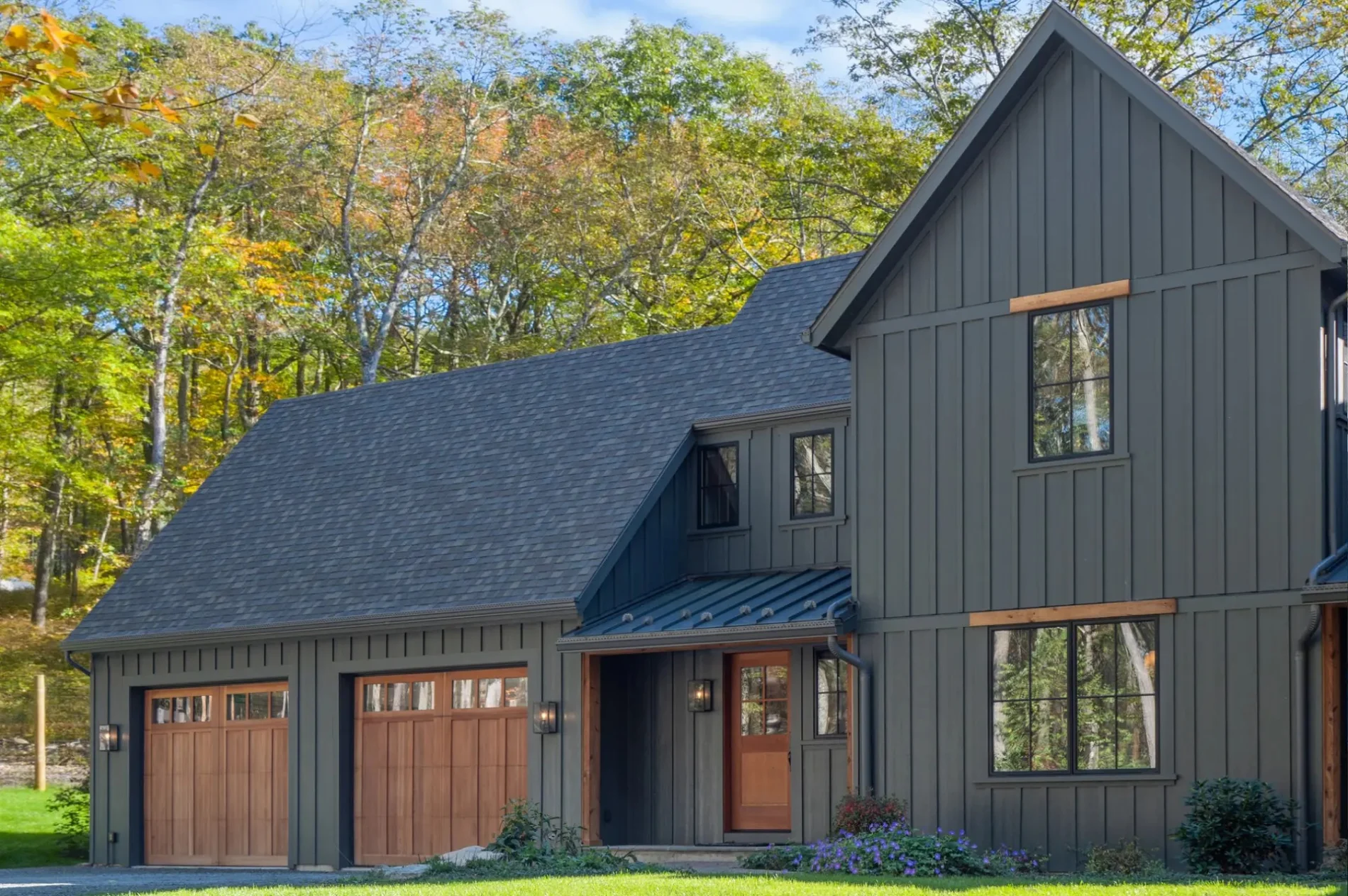Upward angle view of a home with stone accents and yellow siding.