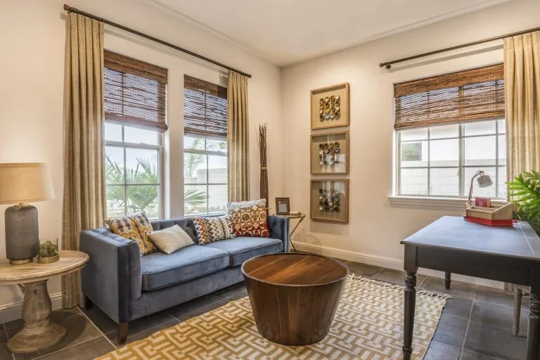 Excellent Window Replacements | Powers Corridor, CO | Peakview Windows, Siding, Stucco Sunlit multi-pane windows paired with woven blinds frame this stylishly furnished living room following modern window replacements.
